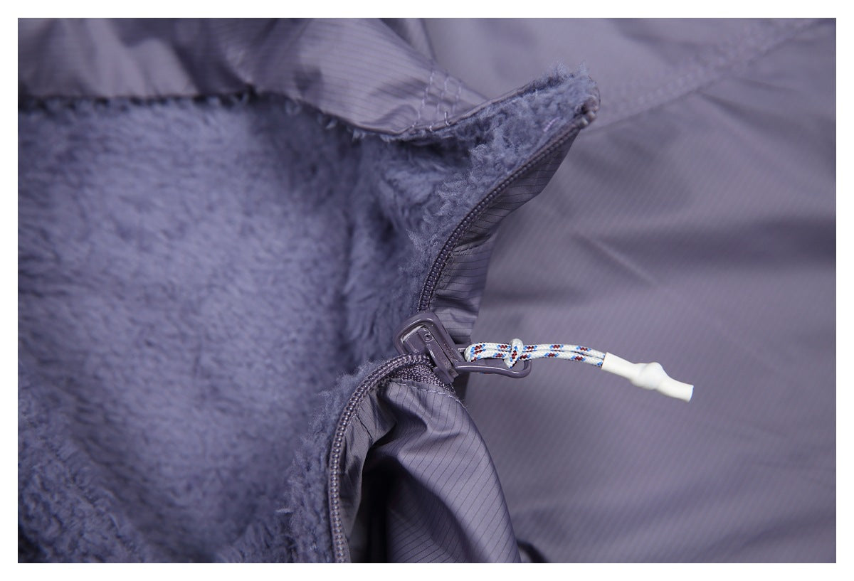 Close-up of the vest's front zipper, cord pull, and plush fleece lining.