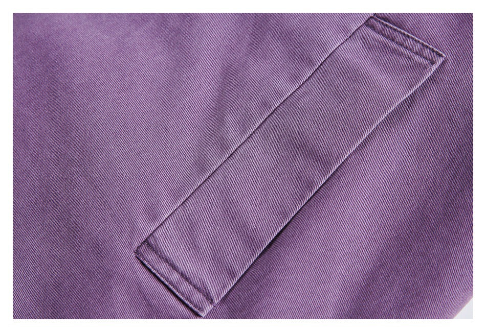 Close-up of a rectangular welt pocket on purple fabric.
