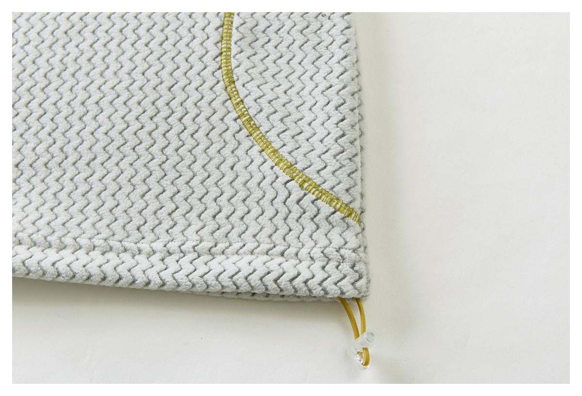 Close-up of a curved yellow-stitched seam and adjustable yellow drawcord with a clear toggle on gray zigzag fabric.
