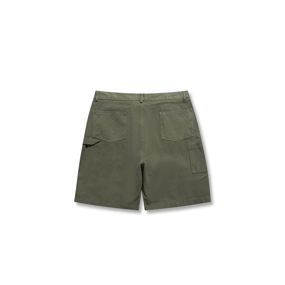 Back view of olive green carpenter shorts showing two patch pockets and a side utility pocket with hammer loop
