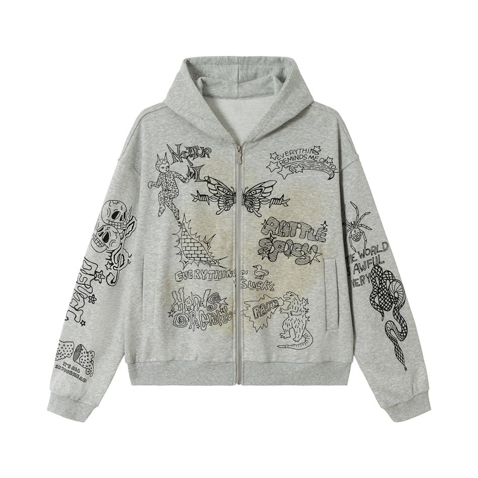 Heather gray zip-up hoodie flat lay with black graffiti prints on chest and sleeves and a faded yellowish wash