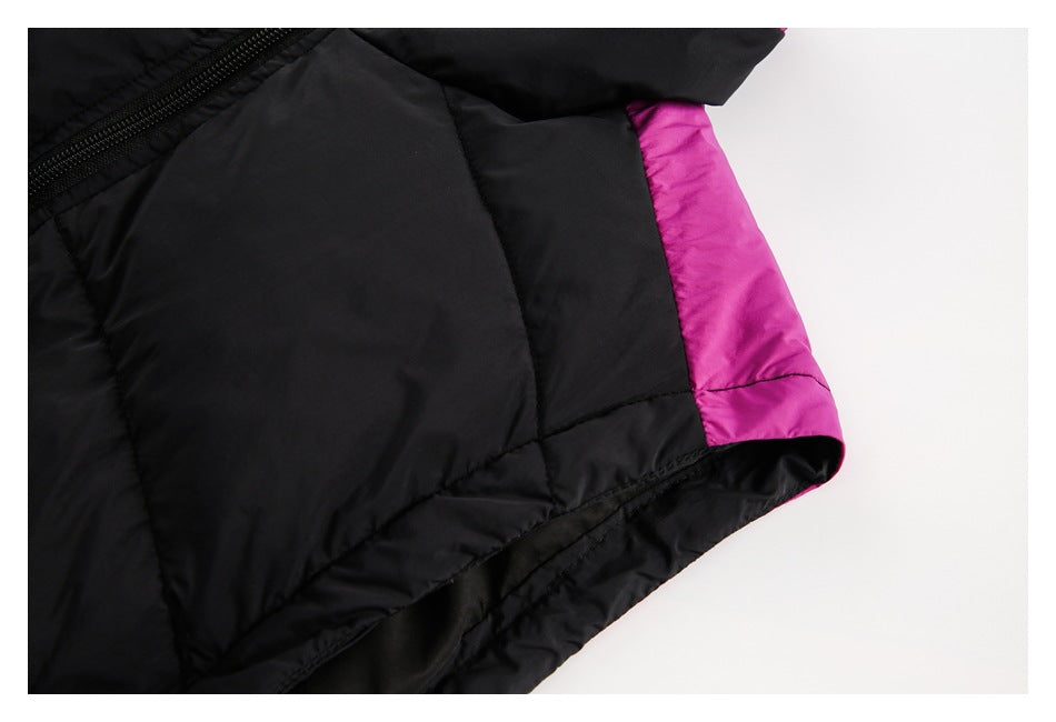 Black quilted jacket hem detail with a magenta side panel and inner lining.