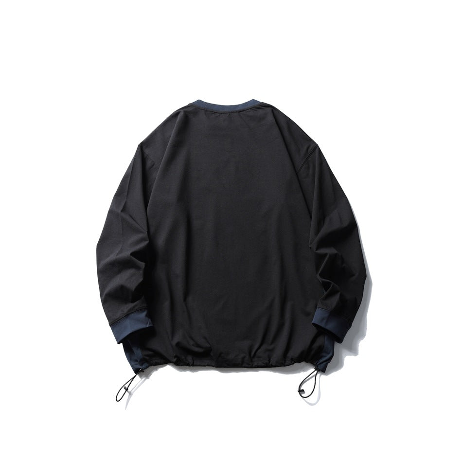 Back view of a black long-sleeve pullover with navy collar and cuffs and adjustable drawcords at the hem.