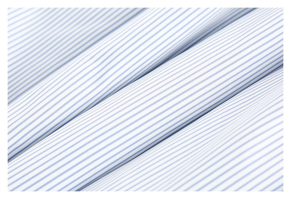 Close-up of white fabric with narrow blue stripes, shown in soft folds.