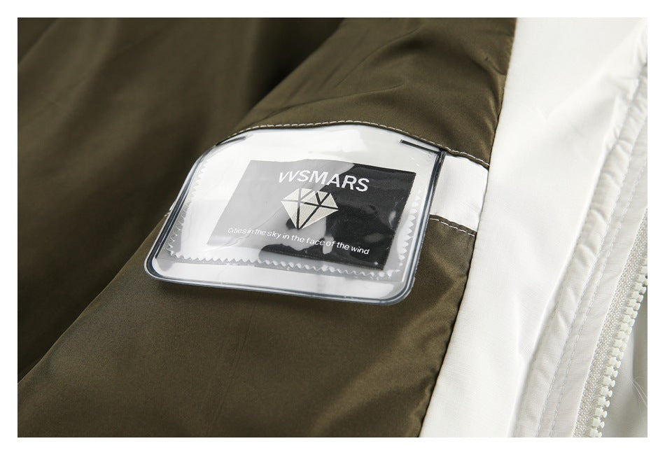 Close-up of a jacket's olive and white panels with a clear pocket displaying a VSMARS label.