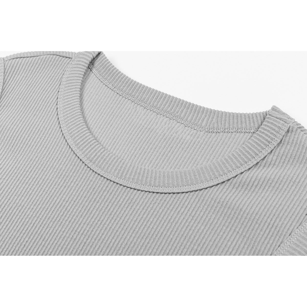 Close-up of the gray ribbed tank top's crew neckline and shoulder seam.