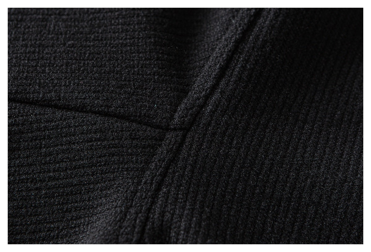 Extreme close-up of black textured fabric with a raised seam.