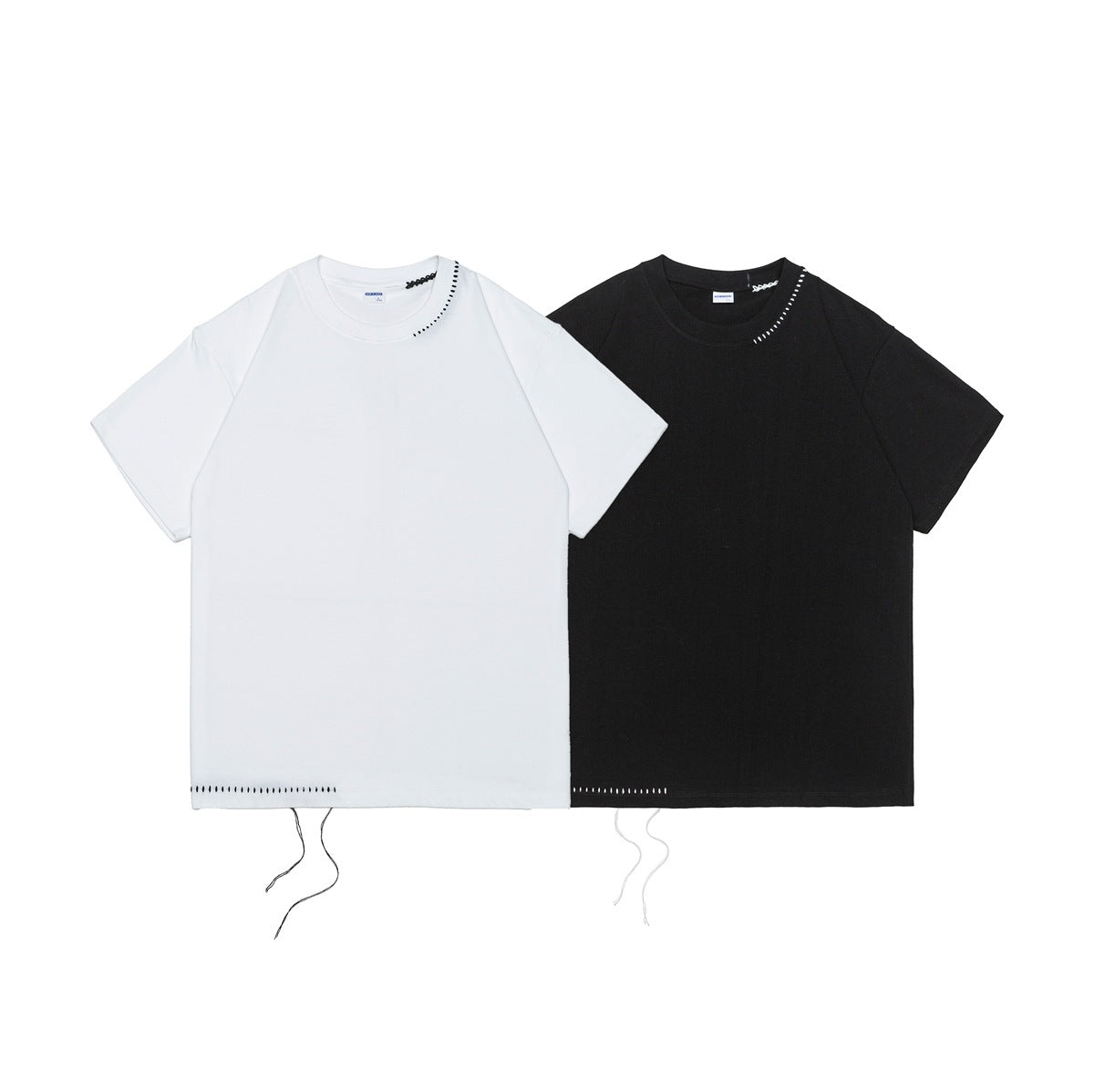 White and black short-sleeve crew-neck T-shirts shown from the front, with contrast stitching and dangling hem threads.