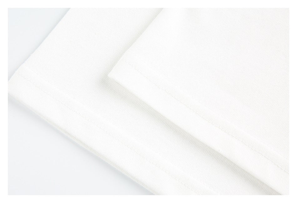 Close-up of a white garment hem with a visible stitched edge.