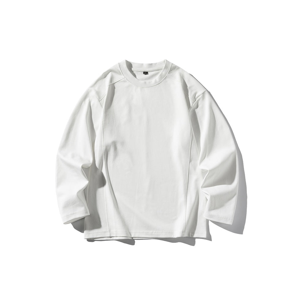 White long-sleeve crewneck top flat lay with drop shoulders and seam details