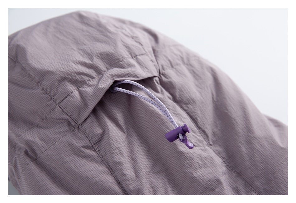 Close-up of a mauve jacket hood with an adjustable drawcord and purple cord lock.