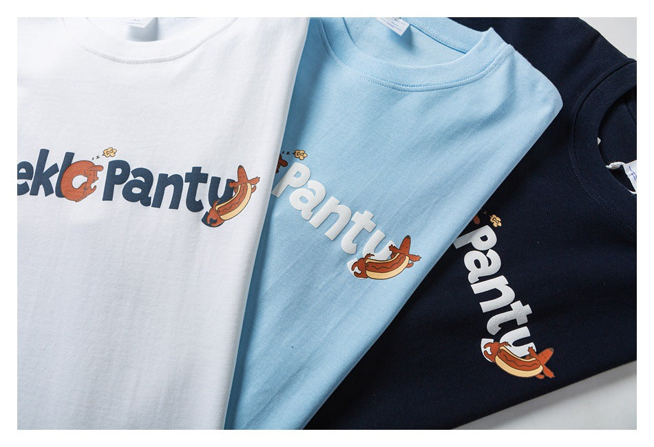 White, light blue, and navy T-shirts arranged together, each with colorful chest lettering and cartoon graphics.
