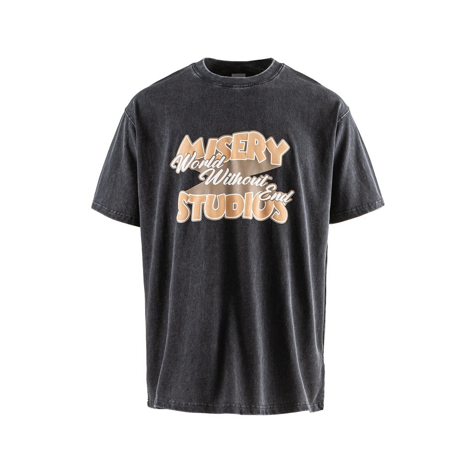 Black washed short-sleeve T-shirt with tan 'MISERY World Without End STUDIOS' graphic on the chest, front view