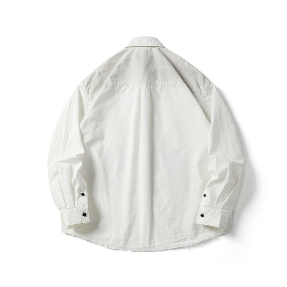 Back view of a white long-sleeve button-up shirt with a yoke seam, center pleat, button cuffs, and frayed hem.