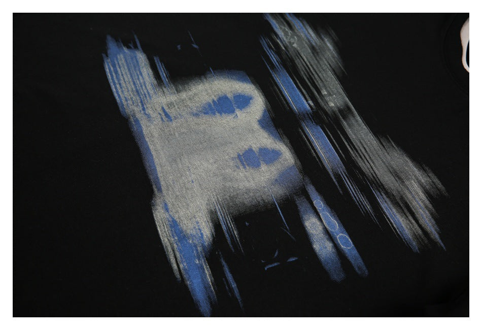 Close-up of a black garment with an abstract blue and gray brushstroke print.