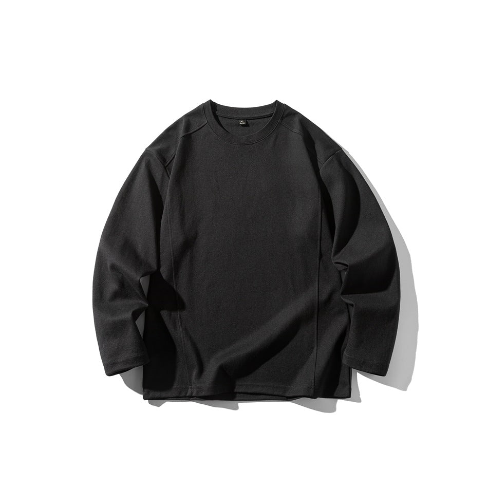 Black long-sleeve crewneck top flat lay with drop shoulders and seam details