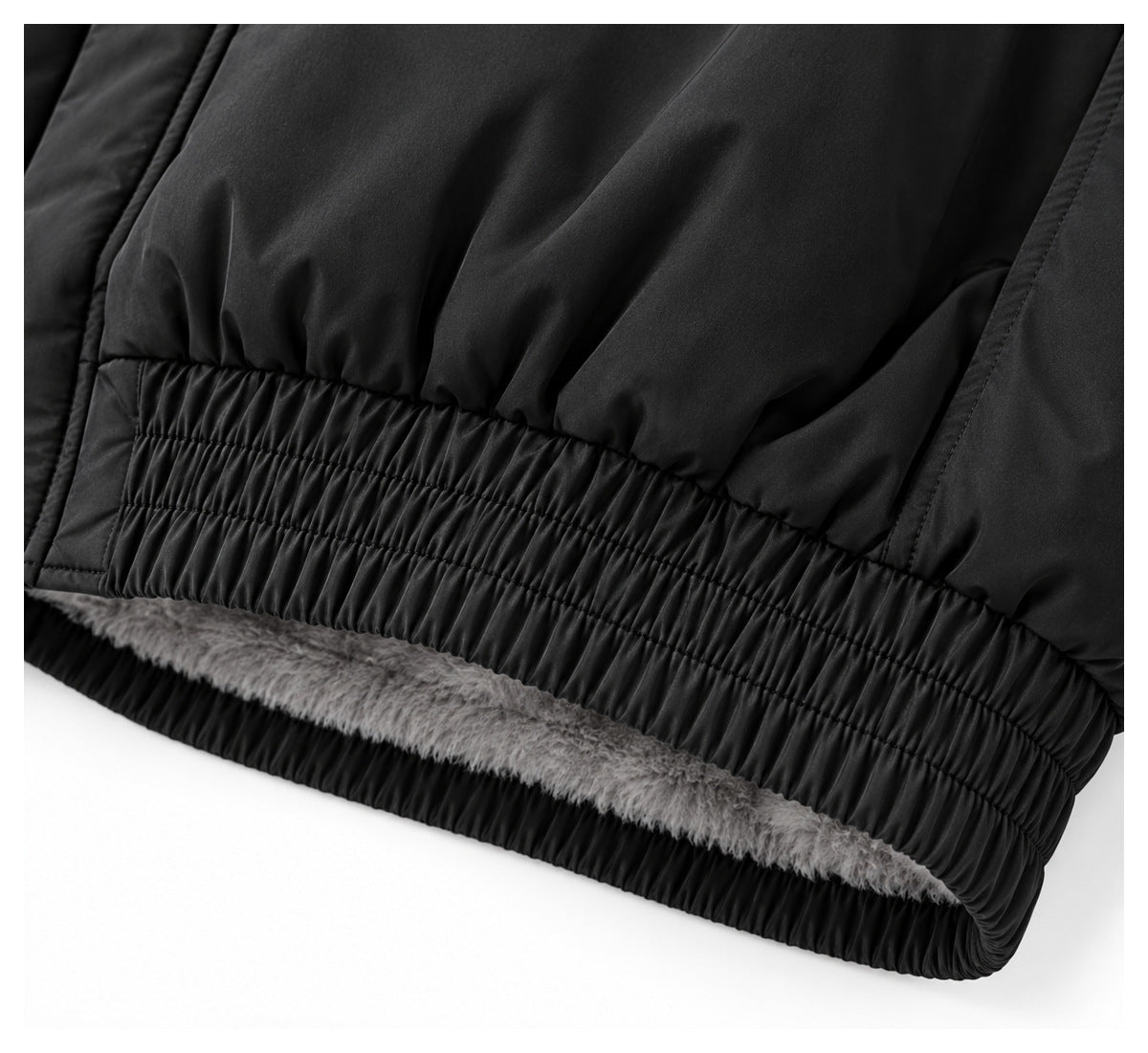 Close-up of the jacket's gathered elastic hem with gray plush lining visible inside.