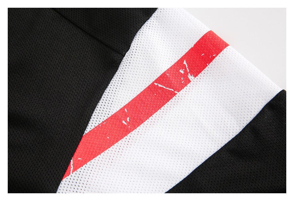 Close-up of a black mesh jersey with a wide white panel and distressed red stripe.