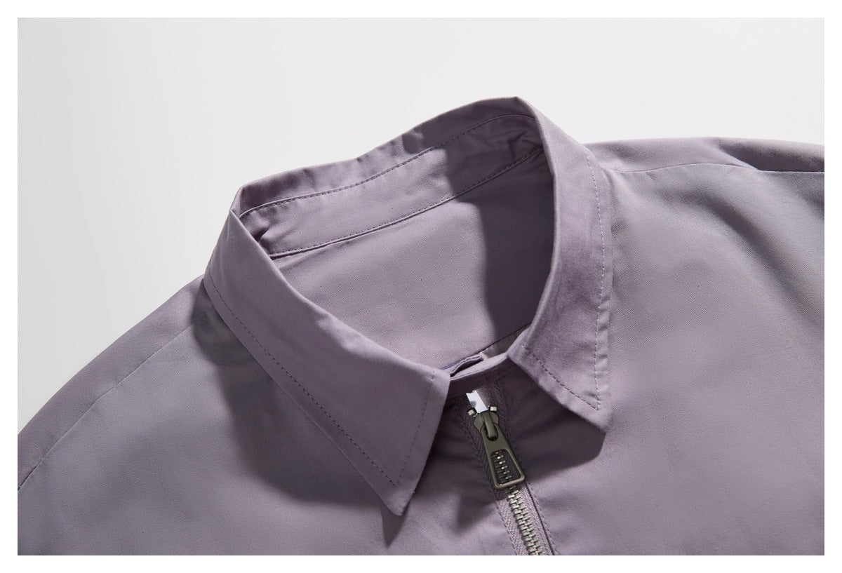 Close-up of a lavender jacket's pointed collar and front zipper.
