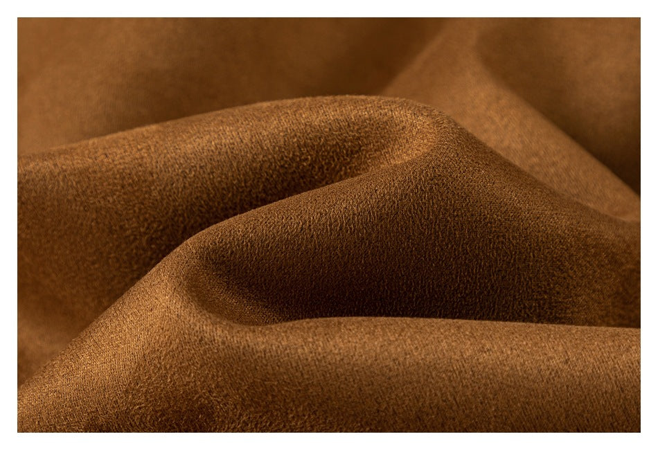 Close-up view of the textured surface of camel-brown fabric.