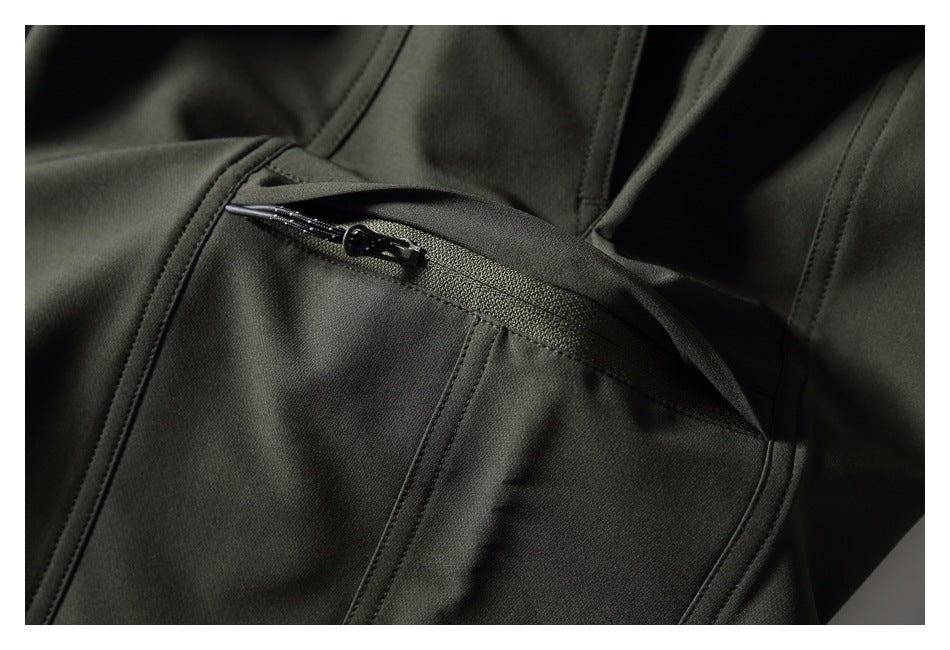 Close-up of a zippered pocket on dark olive pants.