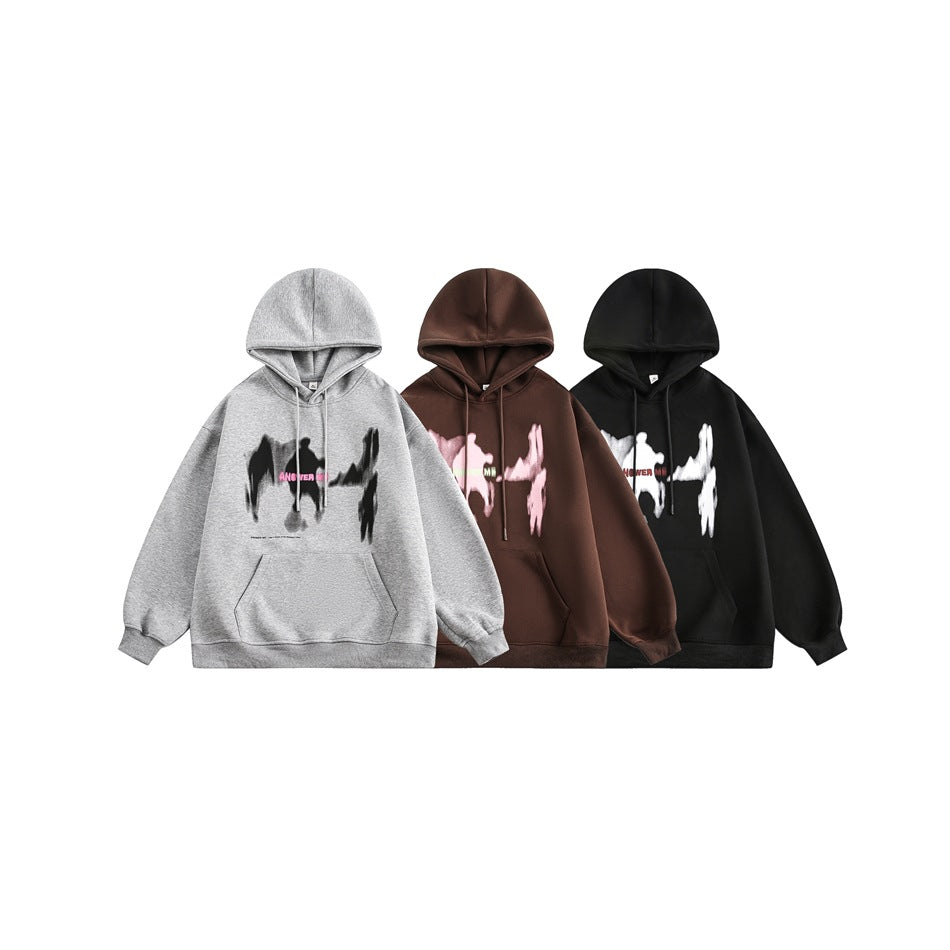 Three front-view hoodies in gray, brown, and black, each with a contrasting abstract chest graphic.