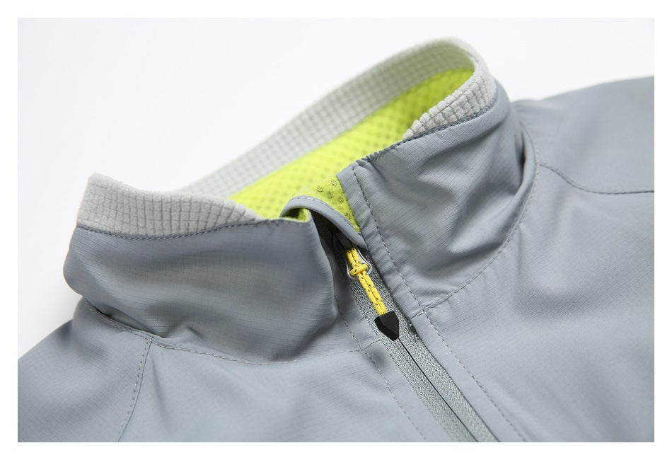 Close-up of the gray jacket's raised collar, with lime lining and a yellow zipper pull.