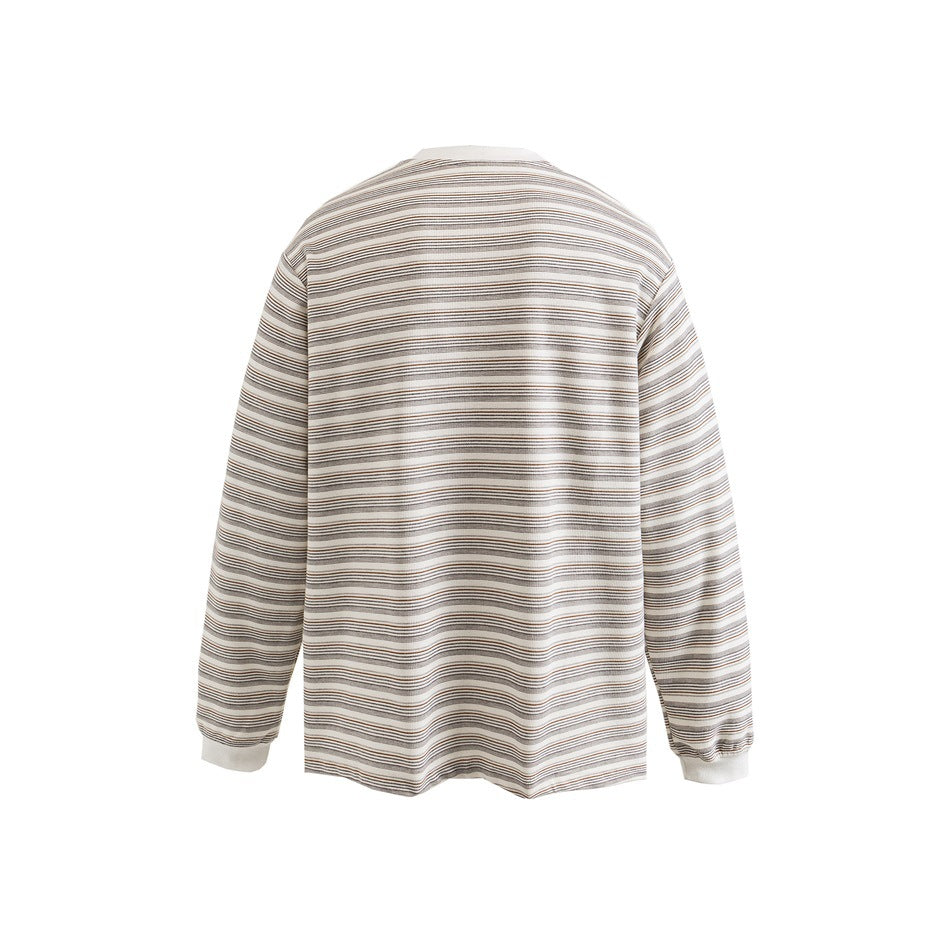 Back view of a cream long-sleeve top with fine horizontal gray and brown stripes and pale cuffs.