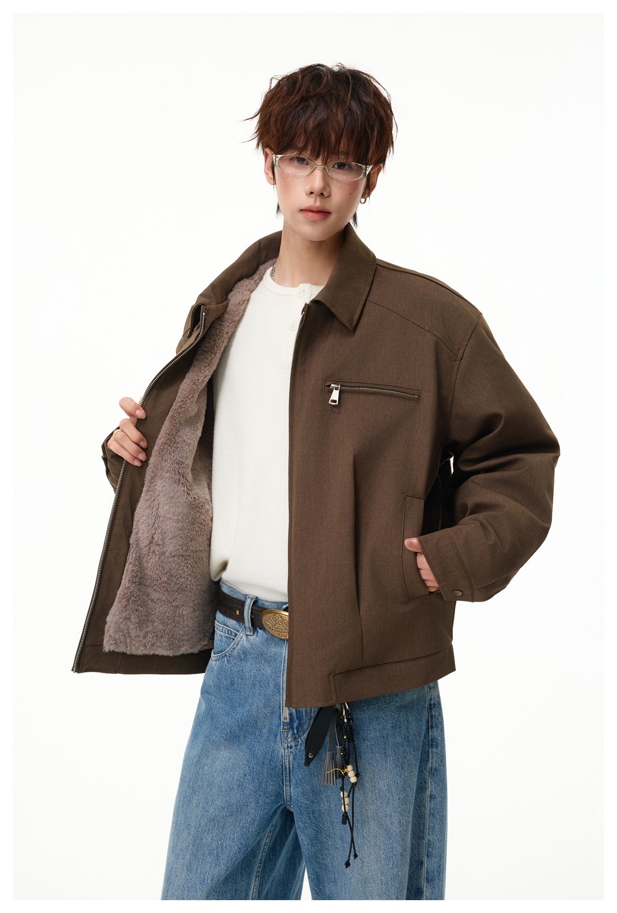 Model holds open a brown jacket to show its soft, grayish mauve lining and front zip closure.