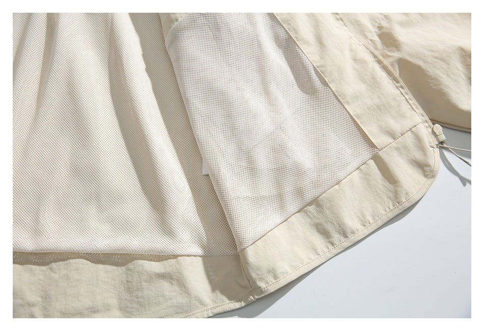 Close-up of the jacket's pale mesh lining and beige fabric edge.