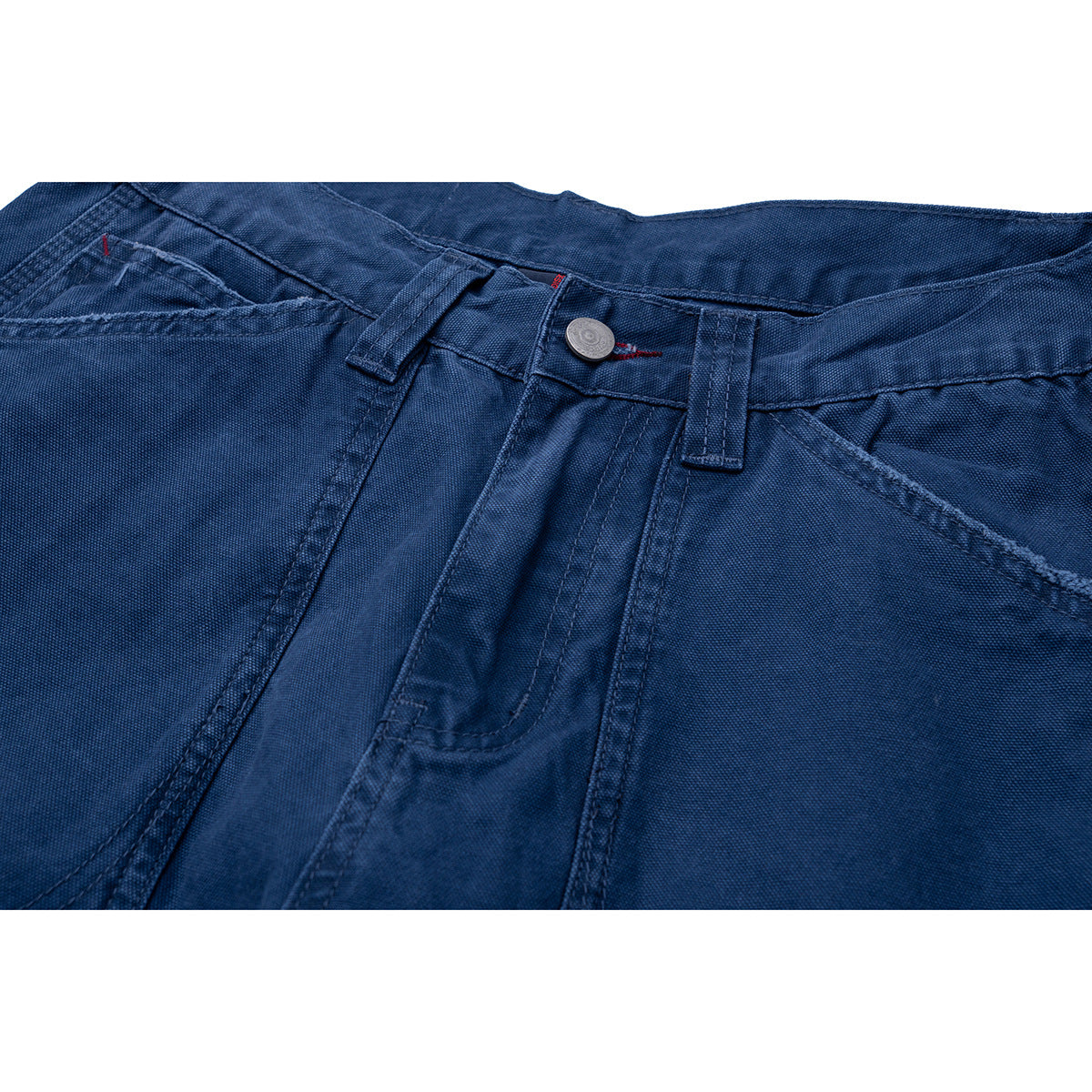 Close-up of dark blue trousers showing the front waistband, button, belt loops, and angled pocket openings.
