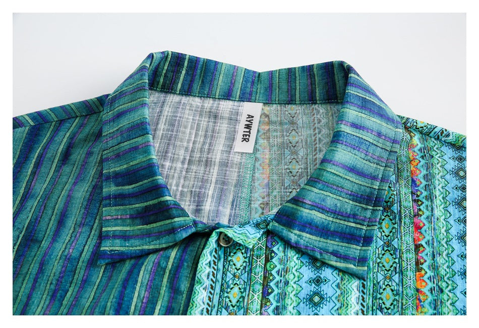 Close-up of the shirt collar, patterned fabric, button, and sewn neck label.
