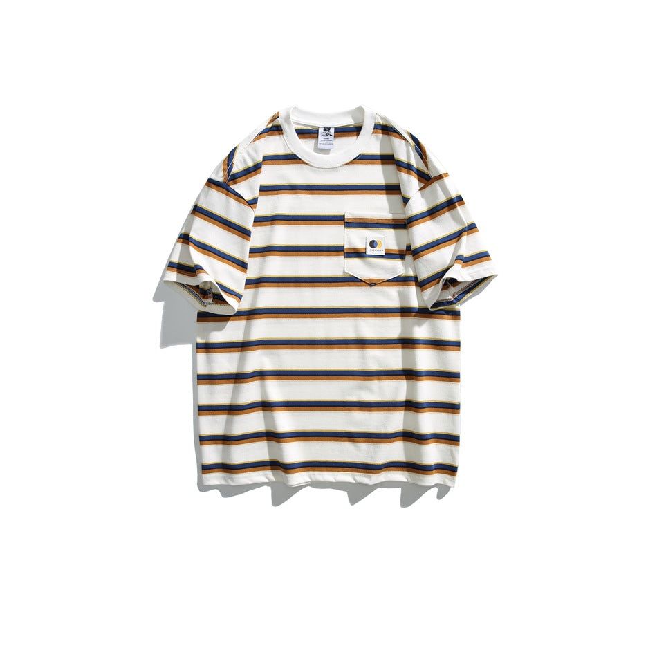 White short-sleeve crew neck T-shirt with navy, orange and yellow stripes and a chest pocket with a small label