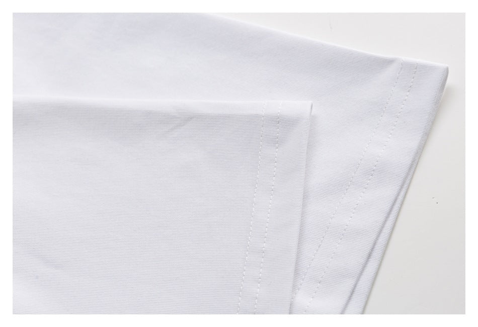Close-up of a white T-shirt hem showing the folded edge and parallel stitching.
