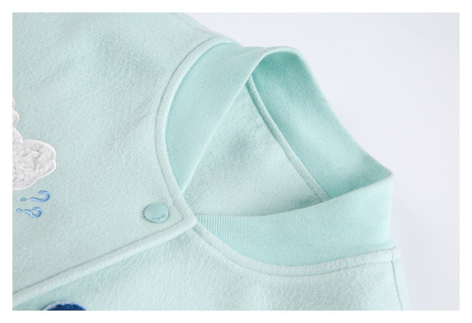 Close-up of the pale aqua jacket's collar, button placket, stitching, and partial appliqué.