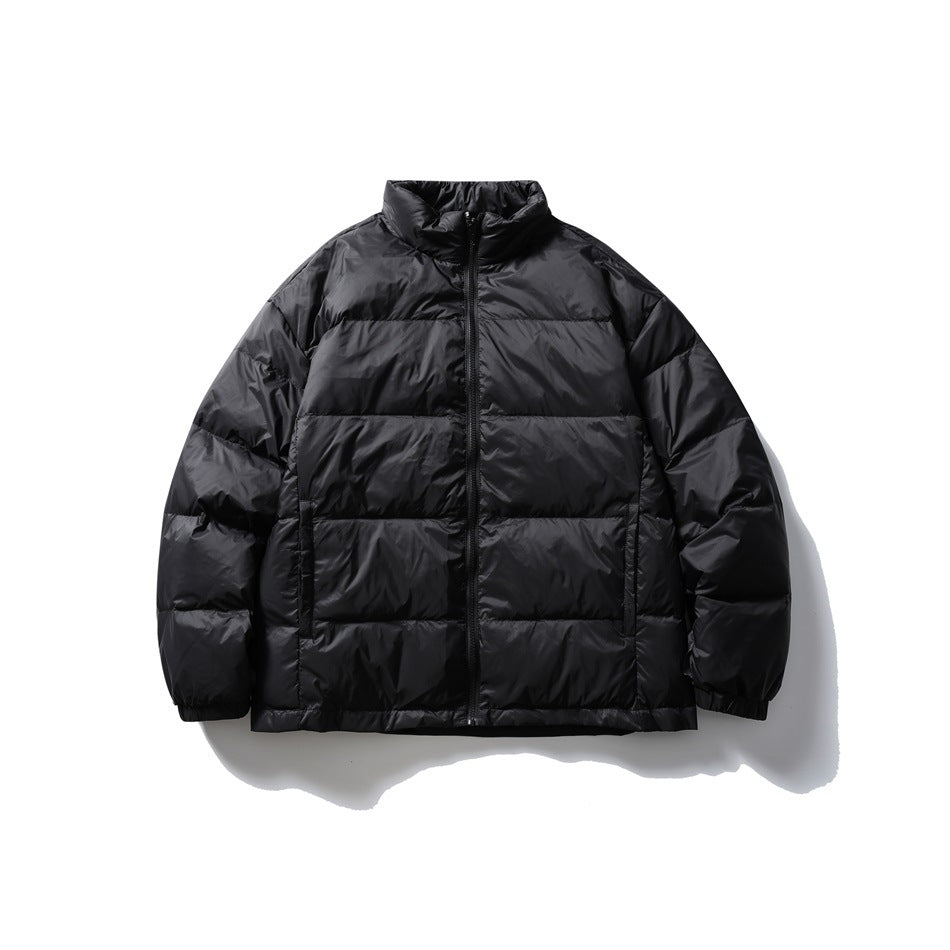 Front view of a black quilted puffer jacket with a stand collar, center zipper, horizontal baffles and side pockets.