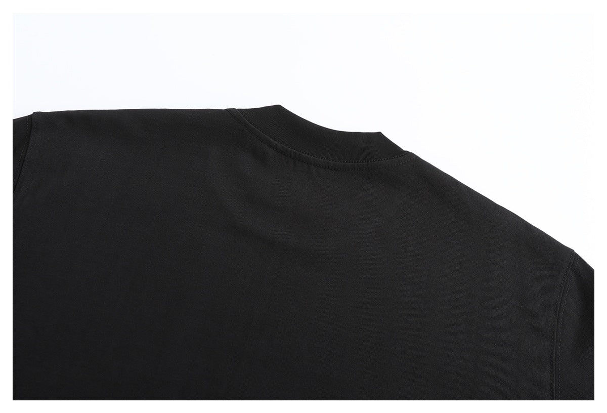 Close-up of the back neckline, shoulder seams, and plain black fabric of a T-shirt.