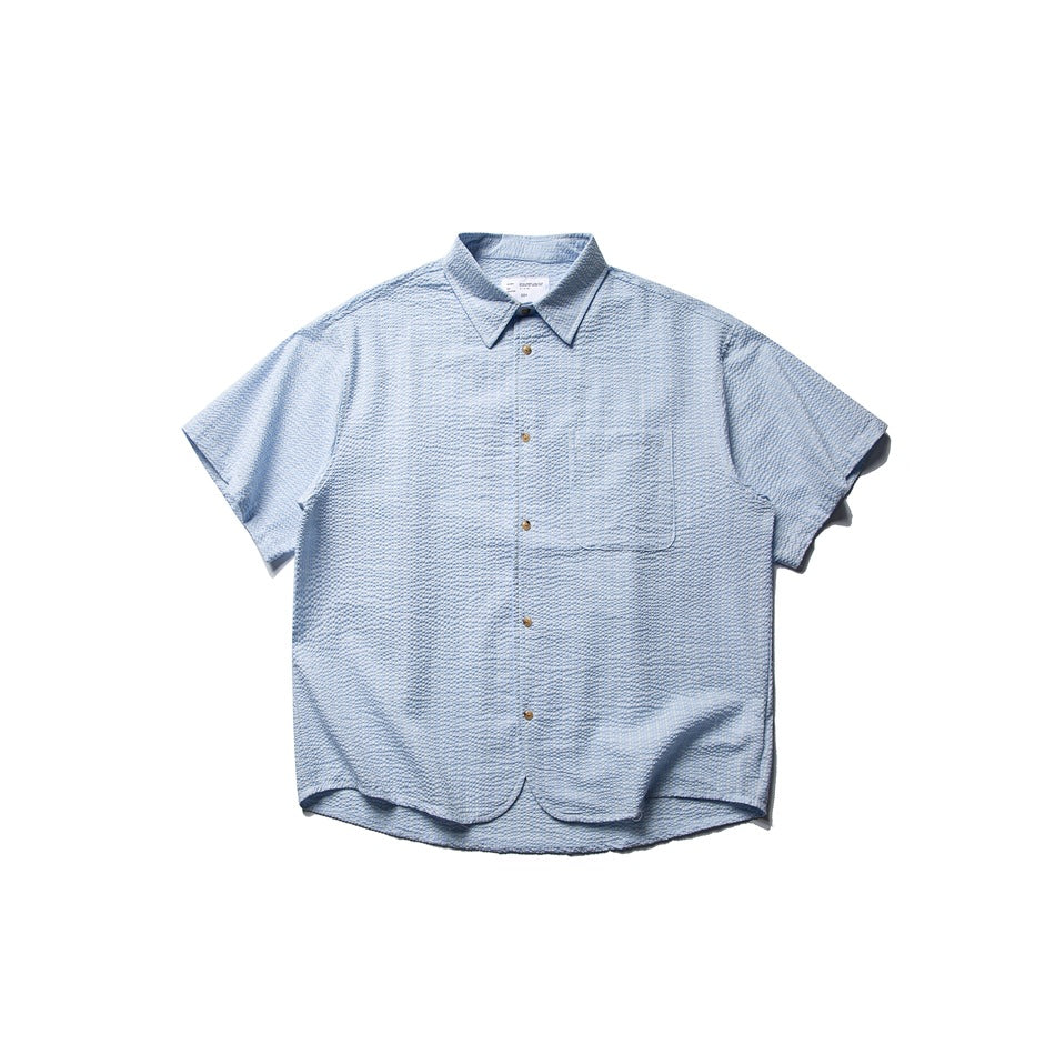 Light blue textured short-sleeve button-up shirt with chest pocket and curved hem, flat lay front view