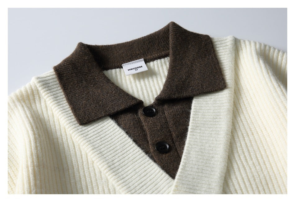 Close-up of an ivory ribbed cardigan with a brown collar, button placket, and a small inside neck label.
