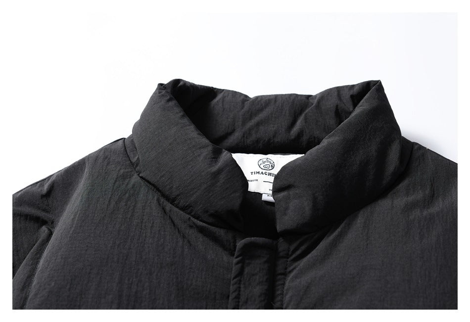 Close-up of the black jacket's high collar and sewn-in neck label.