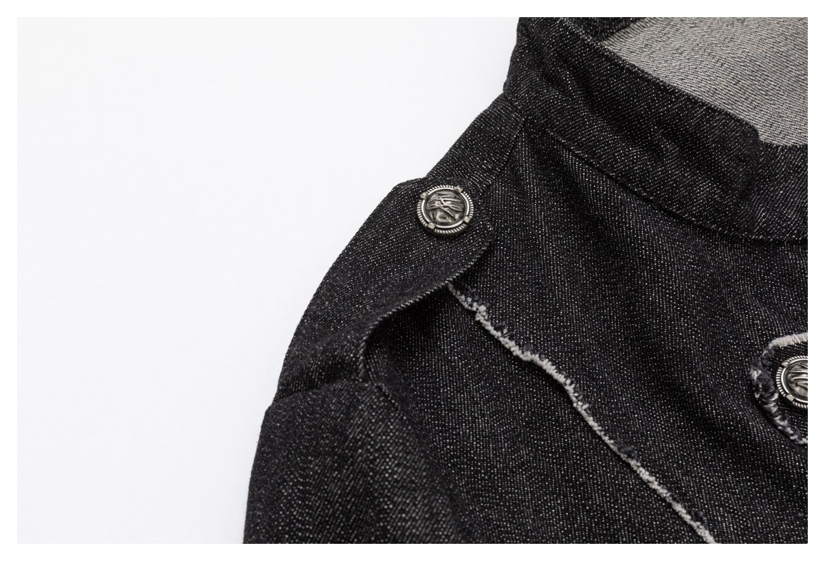 Close-up of a black denim shoulder tab with a metal button and pale frayed seam edging.