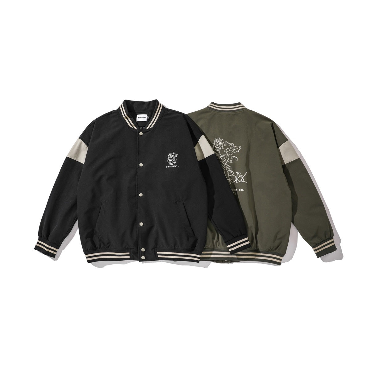 Black jacket shown from the front beside an olive jacket shown from the back; both have cream sleeve panels and striped trim.