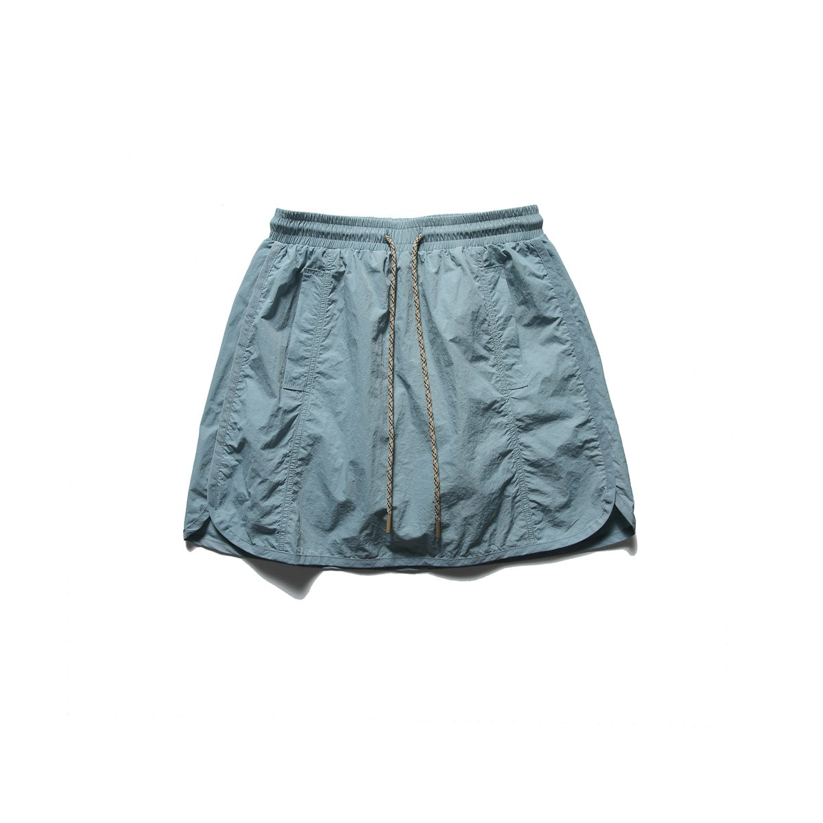 Front view of a pale blue-gray skirt with an elastic waistband, long drawstring, angled pockets and a curved hem.