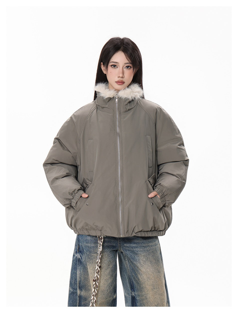 Front view of a model in a taupe-gray zip jacket with a cream fur-trimmed collar and oversized sleeves.