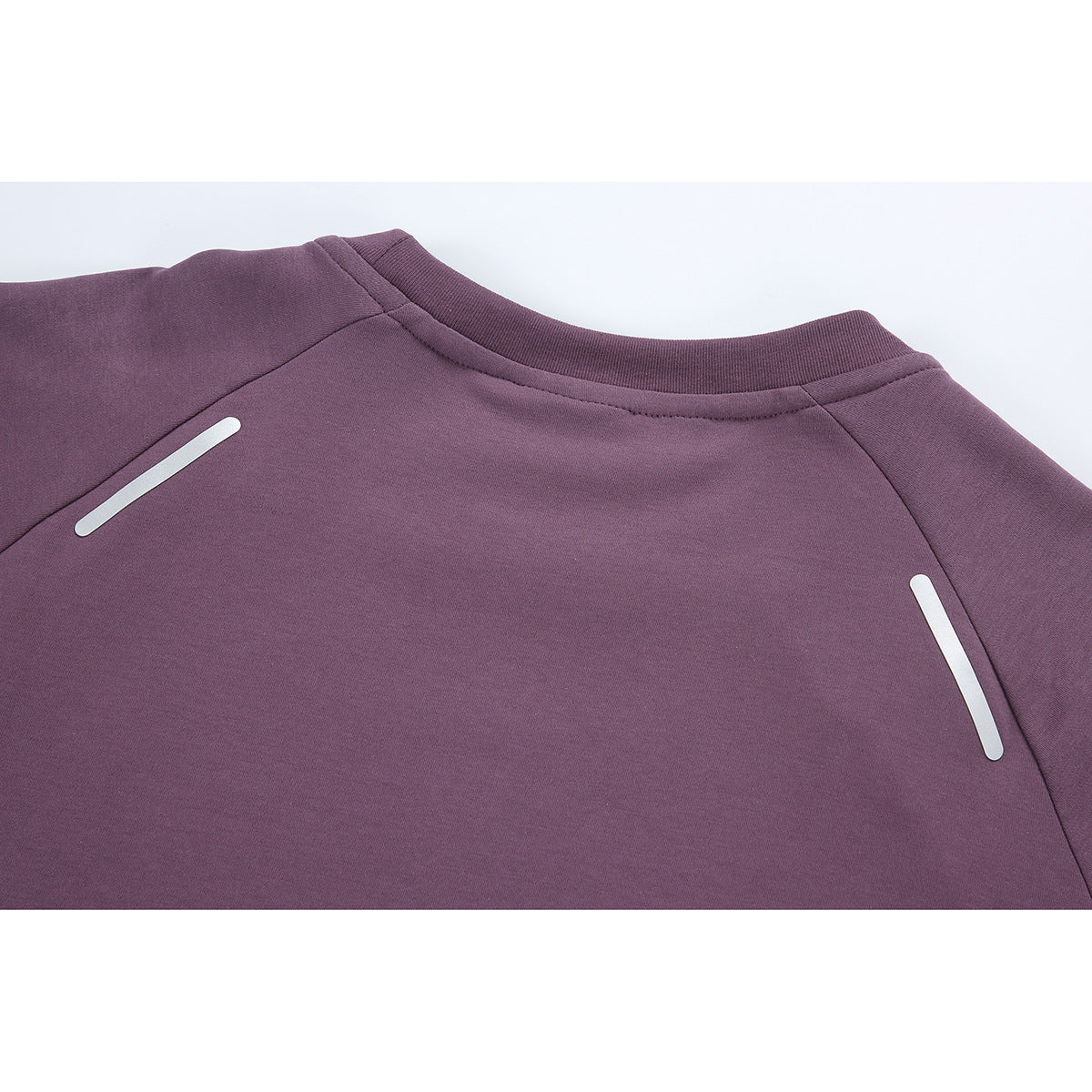 Close-up of the plum top's back neckline and shoulders, with two white reflective strips.