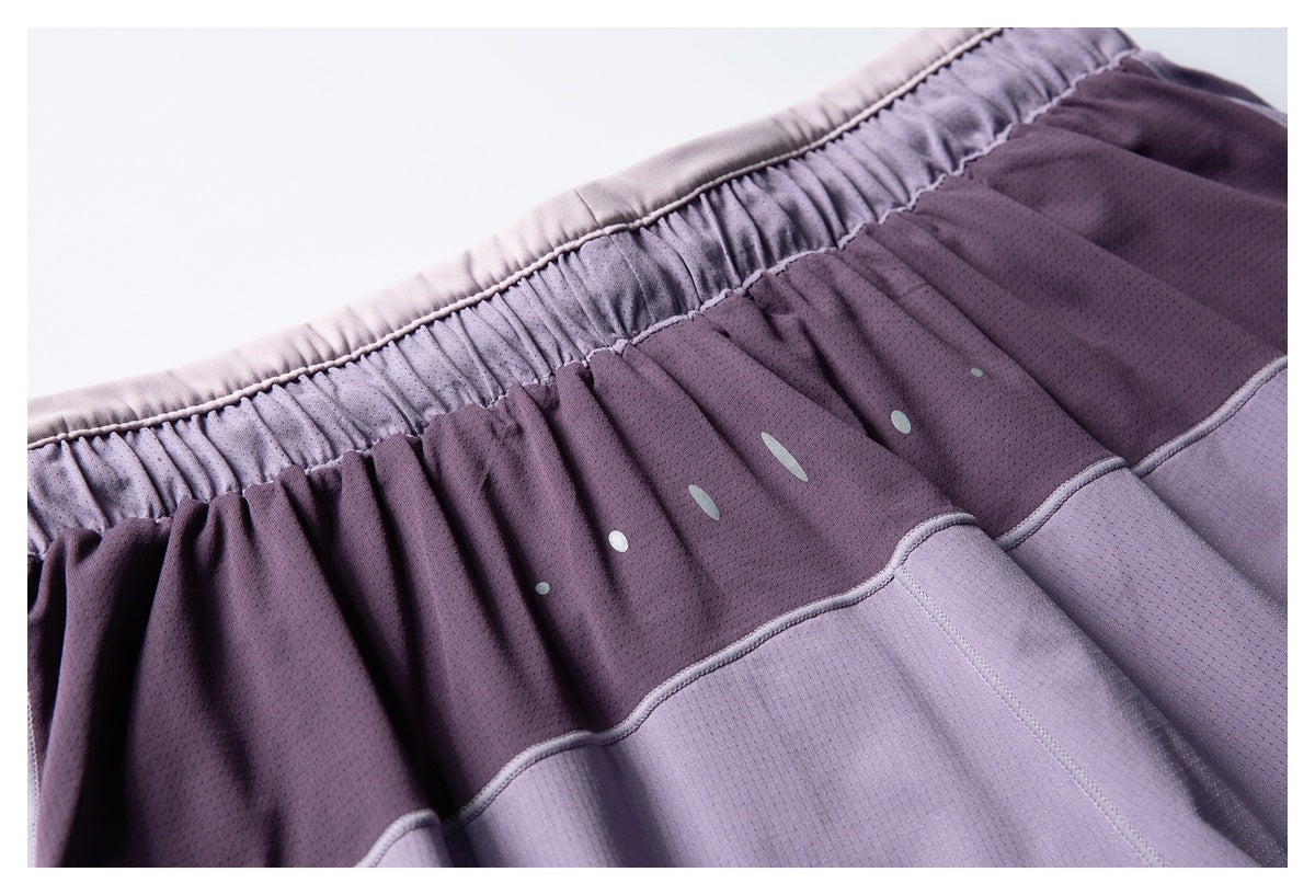 Close-up of a purple perforated garment with a gathered elastic waistband, pale dots and curved panel seams.