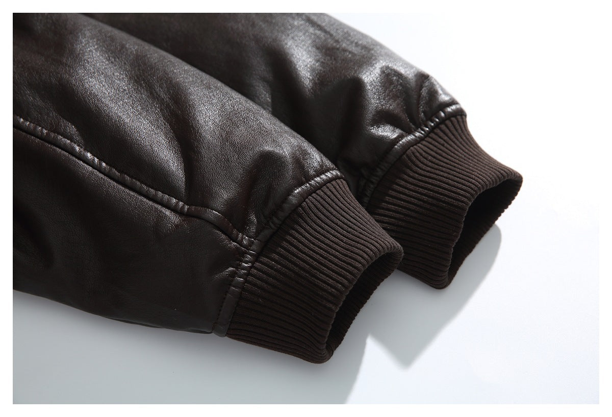 Close-up of two dark brown jacket sleeves with wide rib-knit cuffs and stitched seams.