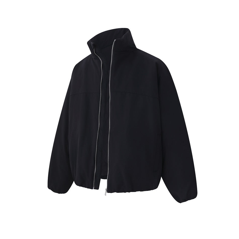 Black stand-collar zip jacket with silver zipper, slightly open, seen from a three-quarter front angle
