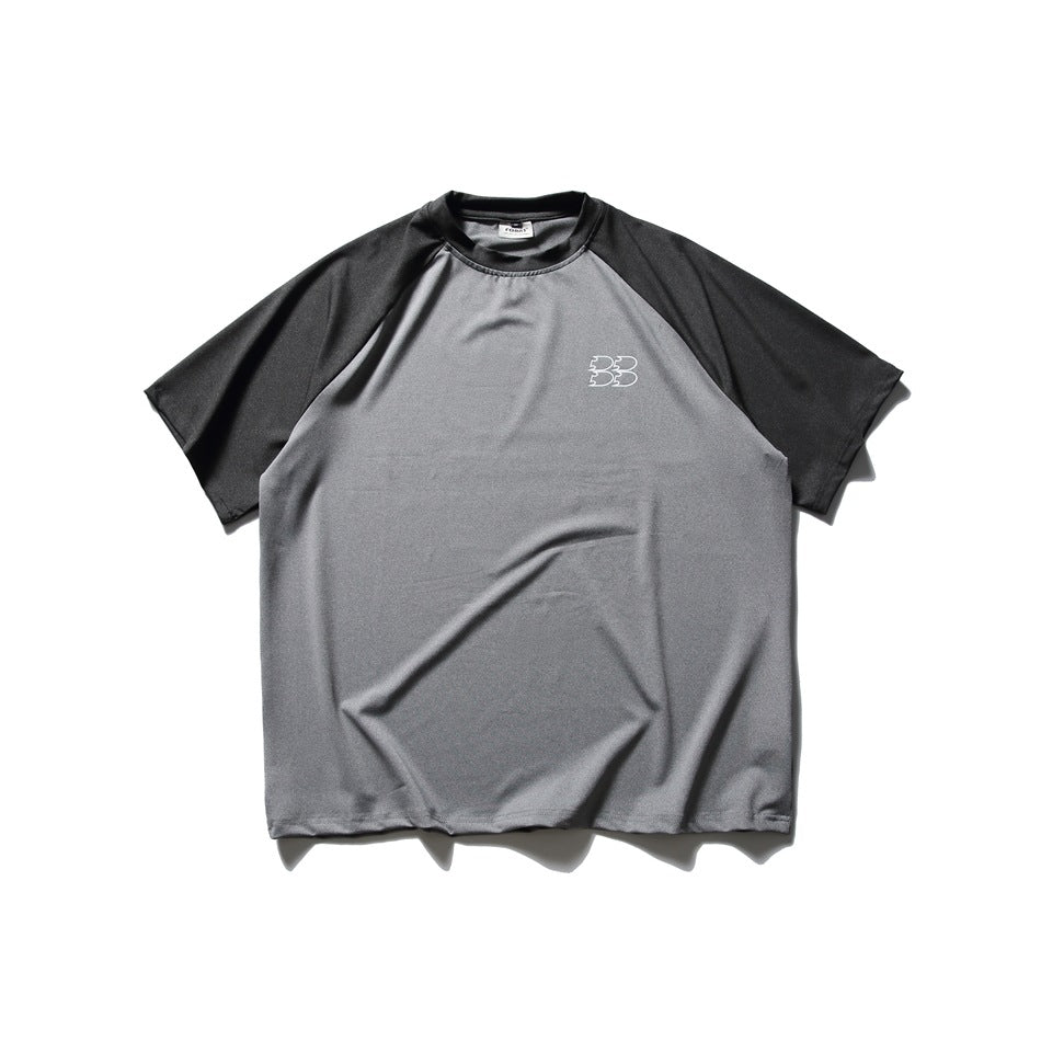 Front view of a gray raglan T-shirt with black sleeves and a small white chest emblem.