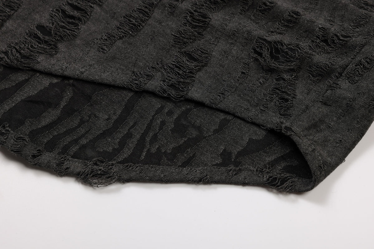 Close-up of the charcoal shirt's folded hem, showing its distressed stripe texture and underside.
